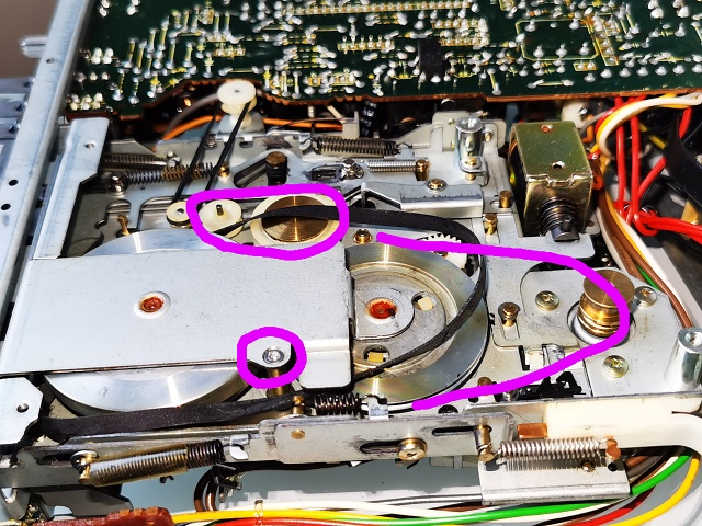 SD-L10 cassette mechanism with pulleys missing belts and stripped screw highlighted